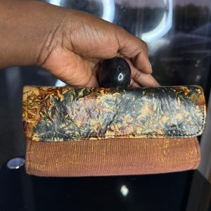 Pochette à main artisanal en cuir de mouton et pagne Faso Danfani tissé à la main, accessoire authentique du Burkina Faso, élégant et original.