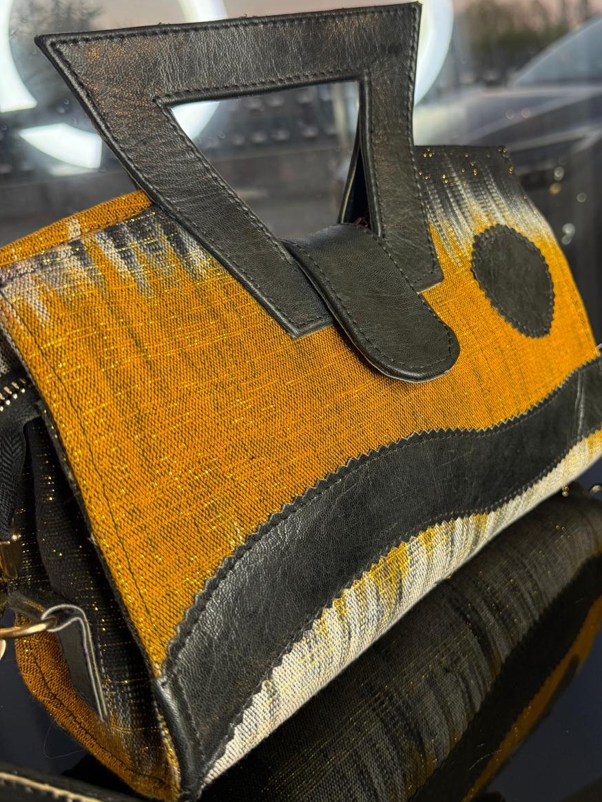 Sac à main artisanal en cuir de mouton et pagne Faso Danfani tissé à la main, accessoire authentique du Burkina Faso, élégant et original.